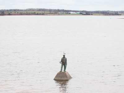 Acadian Fisherman Statue surrounded by water
